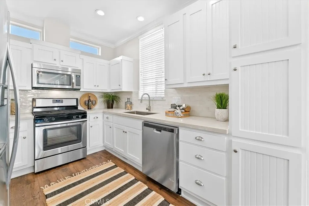New Quartz Kitchen with New Rustic Tile Backsplash, Farmhouse Sink, and Clerestory Windows