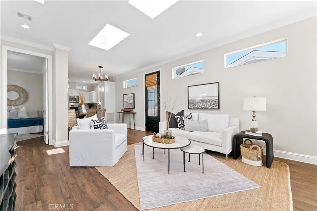 Light & Airy Living Room with Clerestory Windows & Skylights open to Dining Room & Kitchen