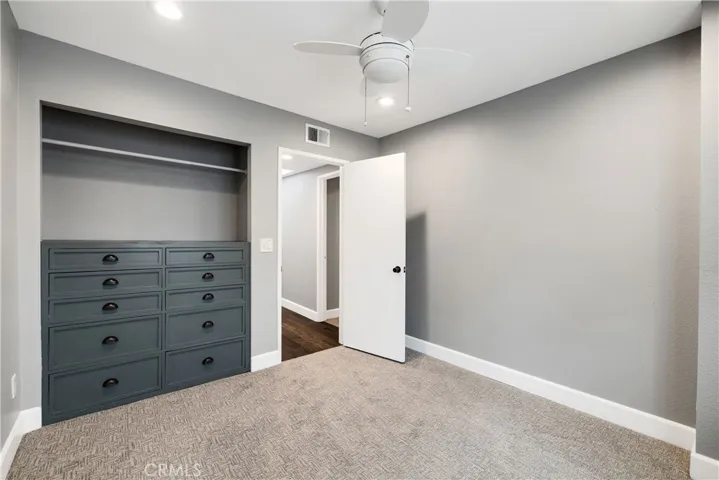 2nd bedroom with built in drawers in closet