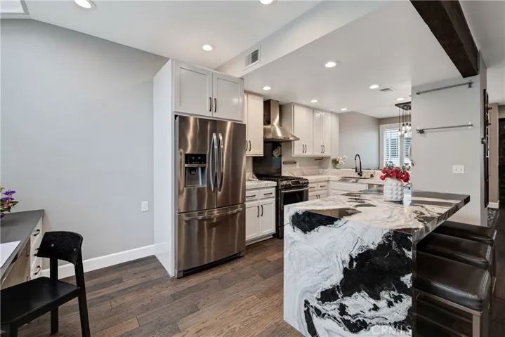 open kitchen with waterfall marble countertop
