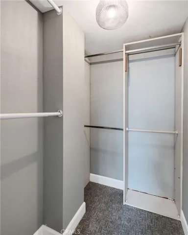 Primary bedroom walk in closet