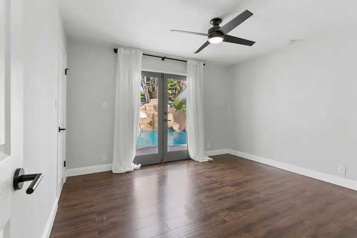 Bedroom #2 downstairs with French doors to back yard.