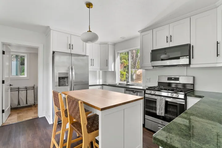 Kitchen with attached half bath with laundry set up