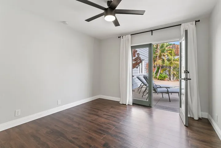 Bedroom #2 downstairs with French doors to back yard.
