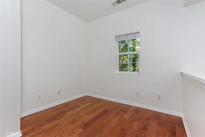 Upstairs loft with hardwood floors. Ideal for home office.