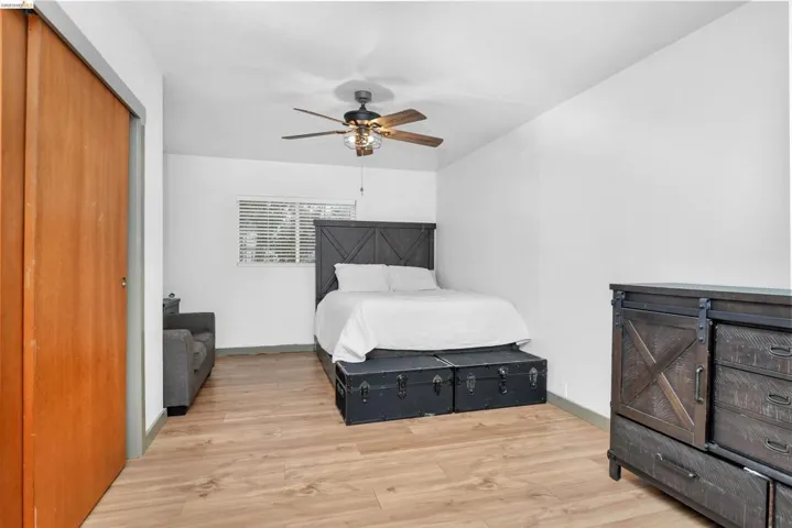 Bedroom featuring a closet, light wood finished floors, and ceiling fan