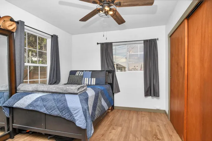 Bedroom featuring a closet, wood finished floors, and ceiling fan
