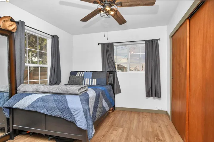 Bedroom featuring a closet, wood finished floors, and ceiling fan