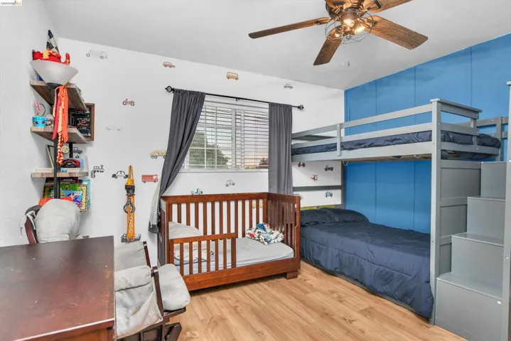 Bedroom featuring wood finished floors and ceiling fan