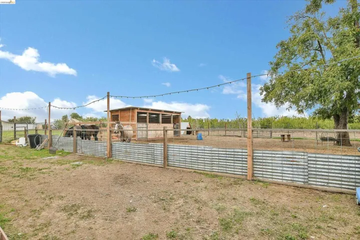 View of yard with an outdoor structure, an exterior structure, and a view of rural / pastoral area
