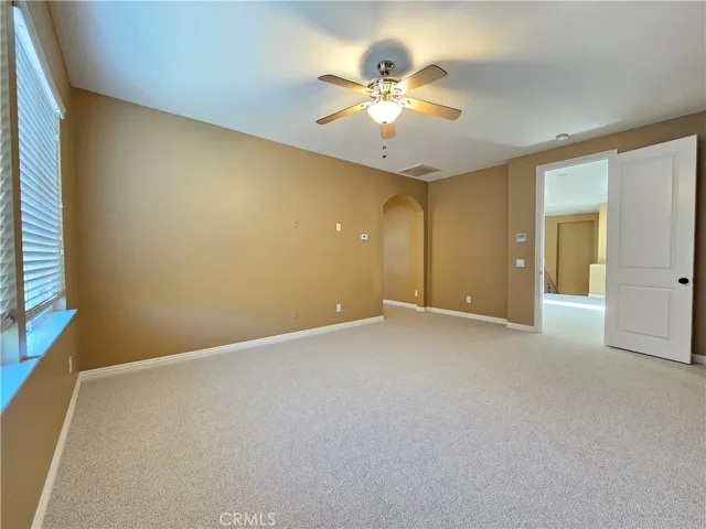 Expansive northeast upstairs bonus room/loft provides highly sought-after flex space for endless possibilities, such as a large game room, private home office, or media center. This bright and airy space features a neutral color palette, plush carpeting, and a ceiling fan for year-round comfort.