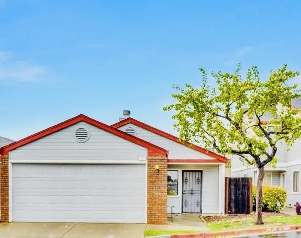 View of front of property featuring concrete driveway and a garage