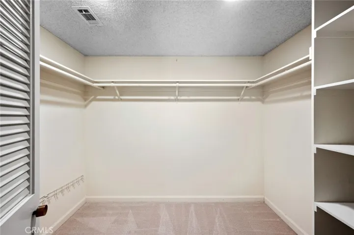 Primary bedroom walk in closet