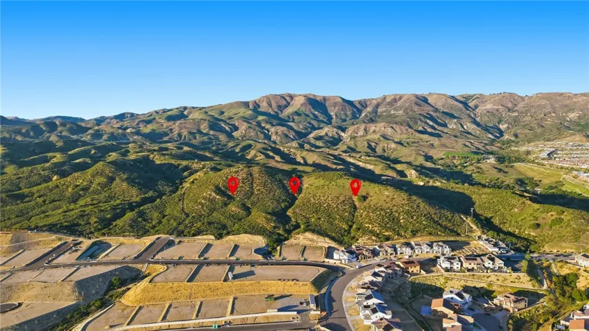View facing North toward the subject property showing the current status of the new home construction. The newly 40 acre property runs to the N, S, E and W of the 3 red markers.