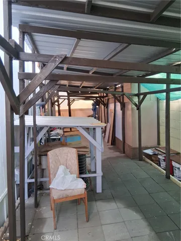 Rear covered patio area with brick and stone pavers