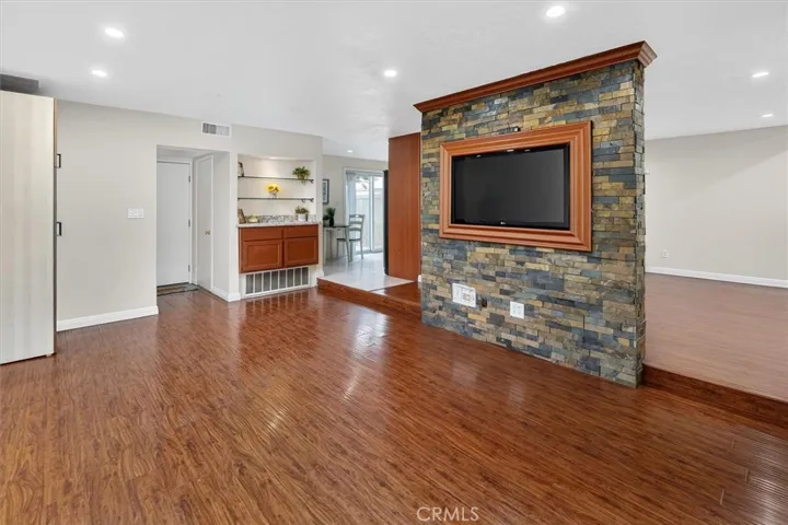 Stunning stone accent wall creates a warm focal point for entertaining