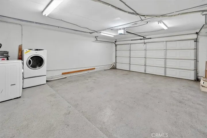 Attached two-car garage for convenient parking and storage. and Laundry Space.
