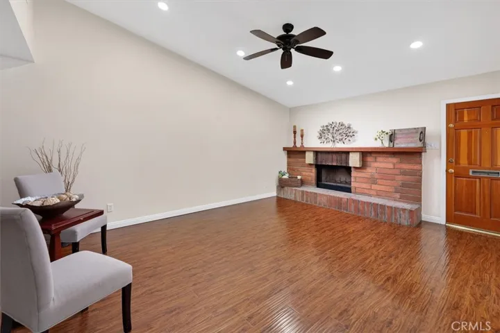 Bright and open space anchored by a cozy fireplace and large sliding doors to the patio.