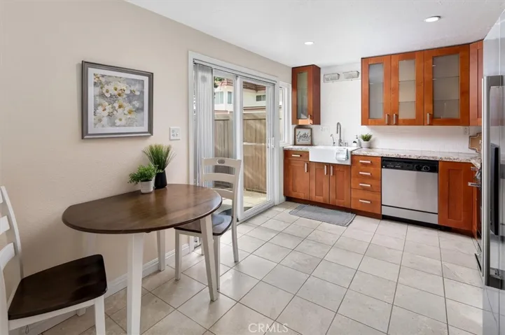 Chef-friendly kitchen with granite countertops, classic farmhouse sink and sleek backsplash.