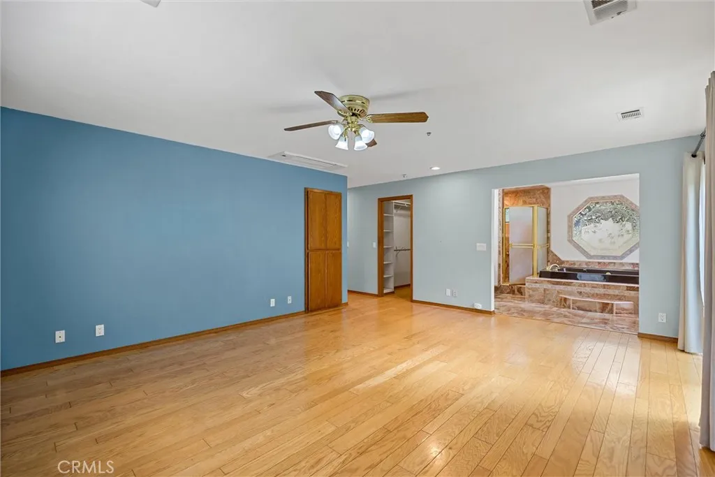 Primary bedroom with two walk-in closets and primary bath suite