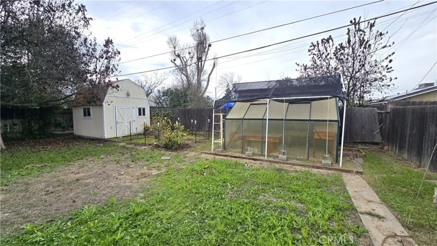 Shed and Greenhouse In Backyard