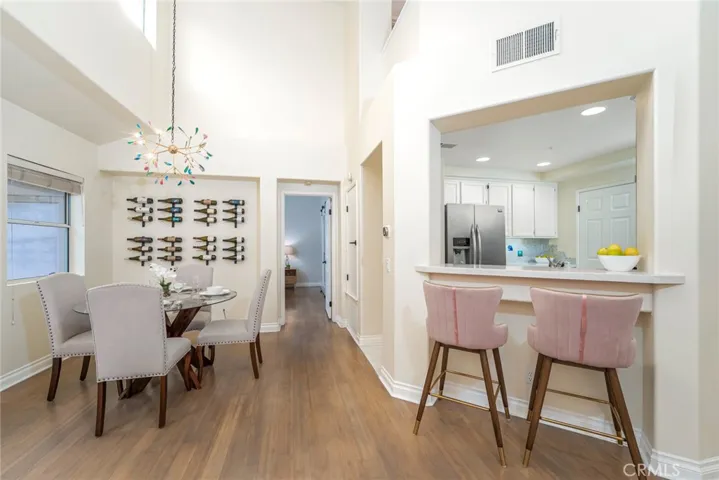 Dining area with a breakfast bar looking into the kitchen