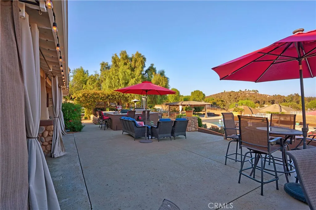 Main home back patio with built in BBQ area that overlooks resort-style pool
