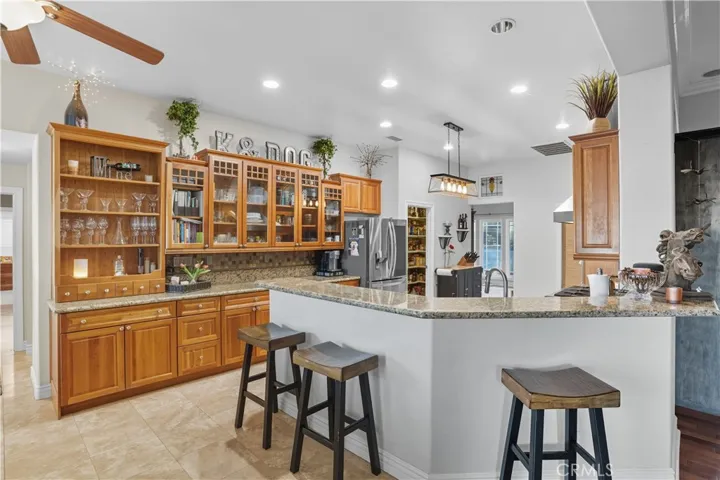 Main Home - Kitchen features designer touches with open concept to eating area and family room