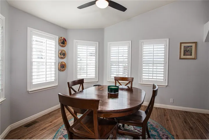 Bright large formal dining room with ceiling fan.