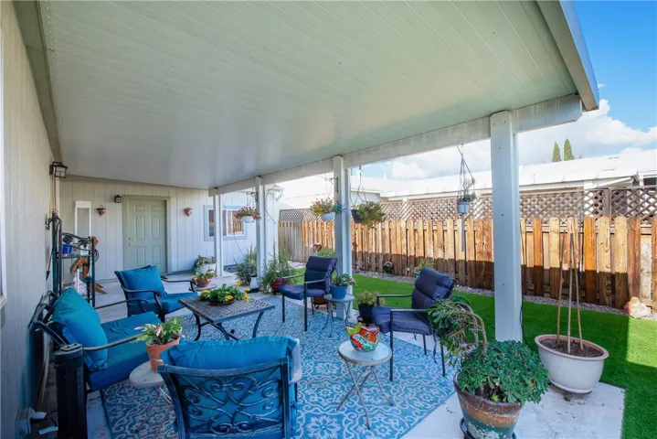 Outdoor living at it's best. Solid ceiling Alumawood patio cover, gardens and artificial turf.