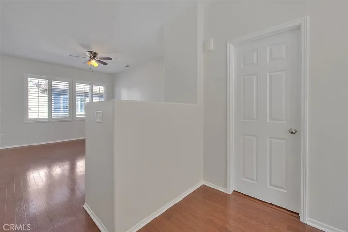Landing to the family room, door to the powder room