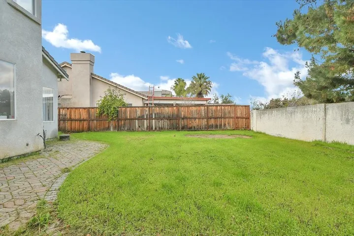 Fenced backyard featuring a patio