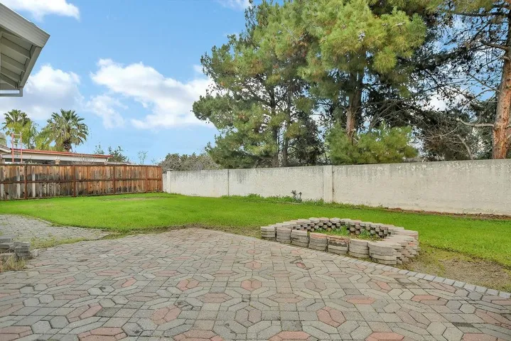 Fenced backyard featuring a patio