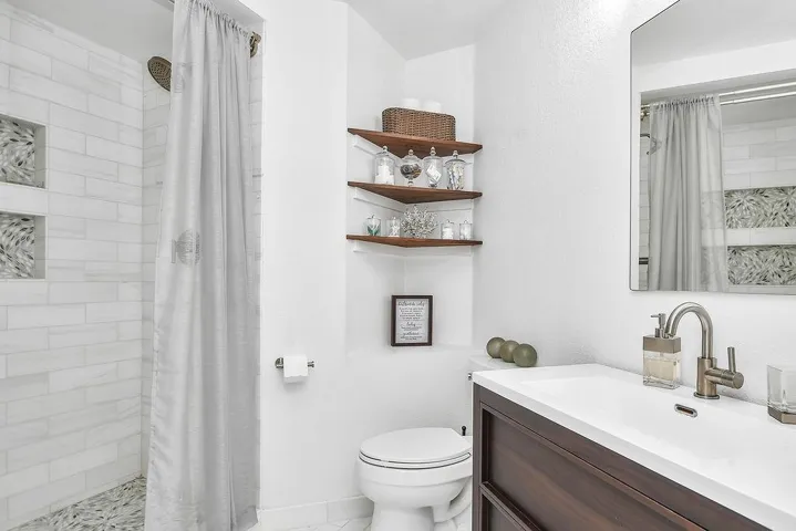 Full bathroom with a shower stall and vanity