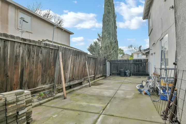 Fenced backyard with a patio area