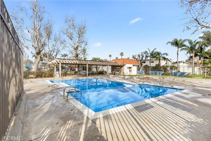 Well-maintained community pool within a peaceful residential setting.