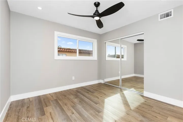Bright bedroom showcasing room size, natural light, and generous closet space.