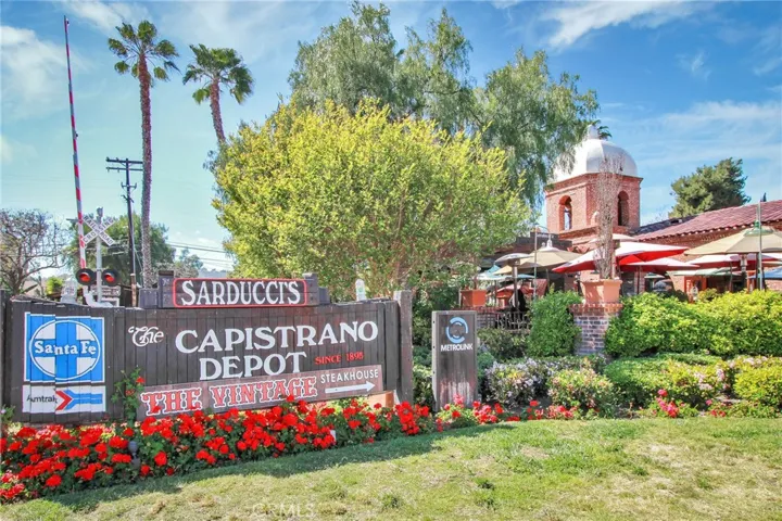 Historic Capistrano Depot area featuring Sarducci’s, dining patios, and direct Metrolink access.