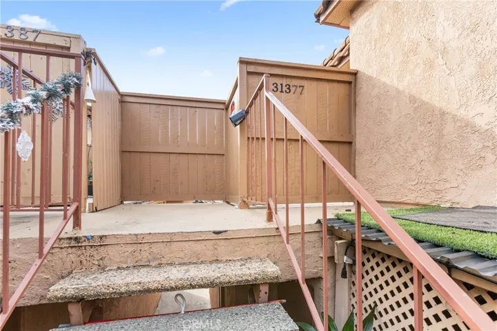 Private gated entry leading to the enclosed patio and home entrance.