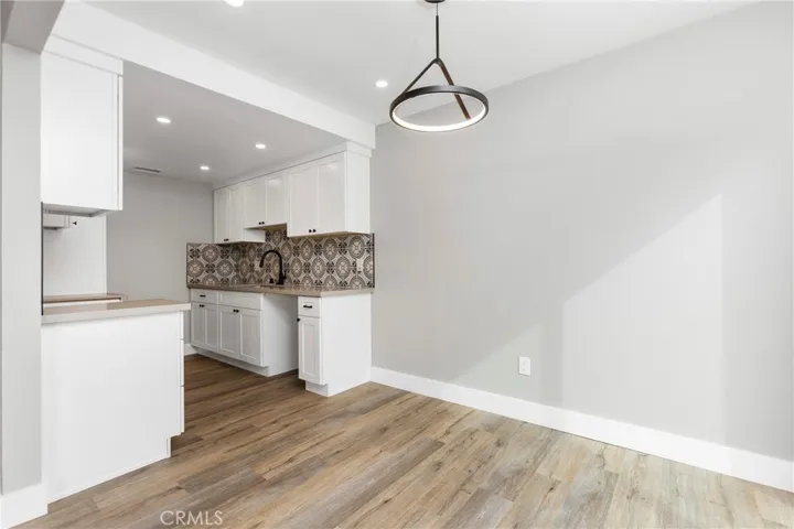 Open dining area with modern pendant lighting and easy flow to the updated kitchen.