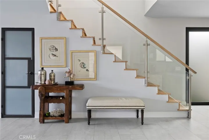 Modern glass and metal staircase with large closet/pantry under