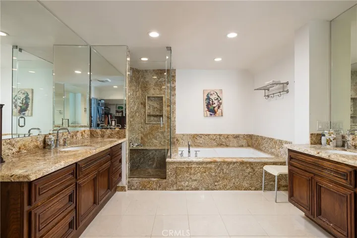 Large primary bathroom with tub, walk-in shower and ample vanity space