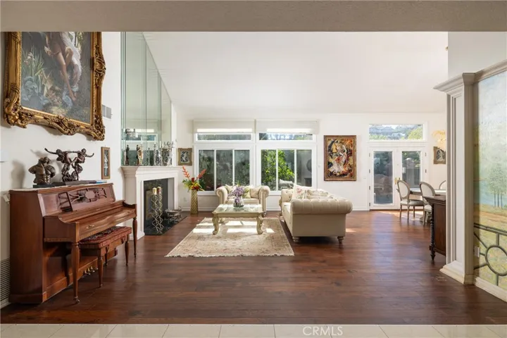 Formal living room with backyard views and accent fireplace treatment