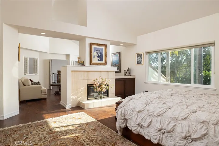 Primary bedroom with double-sided fireplace and retreat area