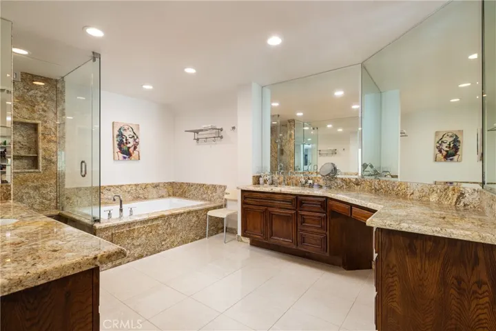 Large primary bathroom with tub, walk-in shower and ample vanity space