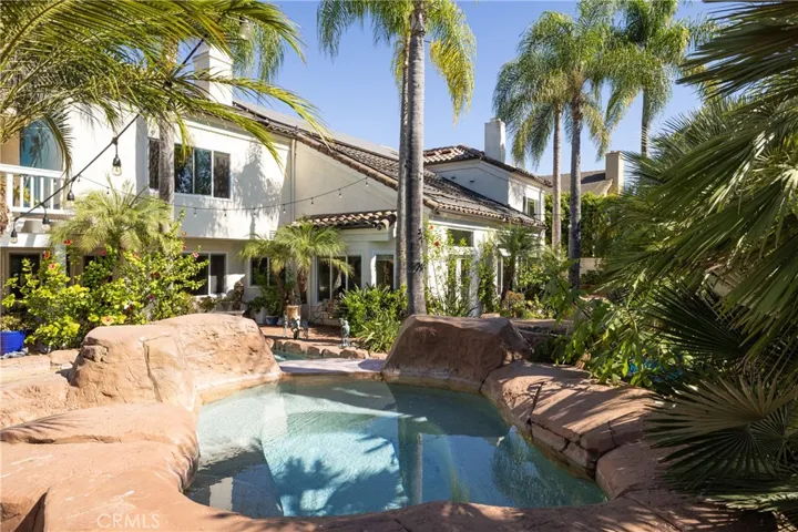 Resort style jacuzzi with spill-over waterfall into your pool