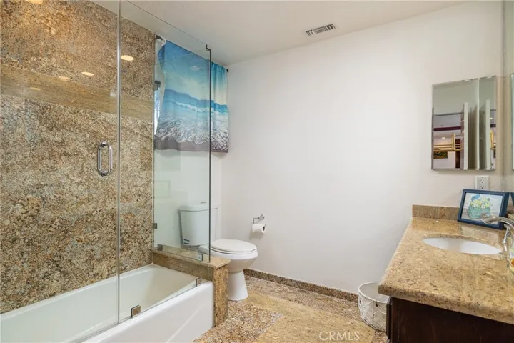 Full bathroom attached to the game room offers multiple uses of that space