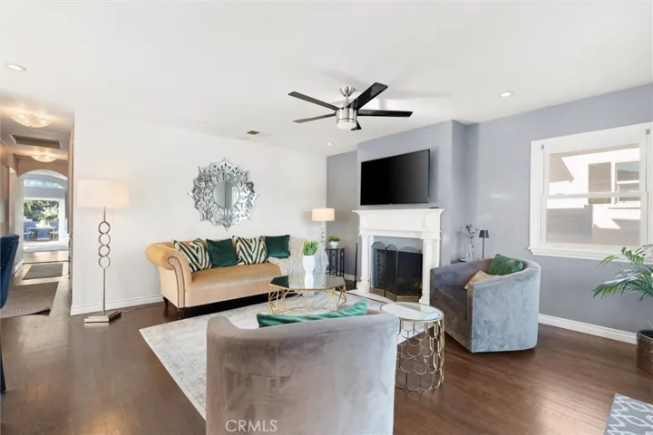 View of living room from front entrance. Built in fireplace and a lot of natural light