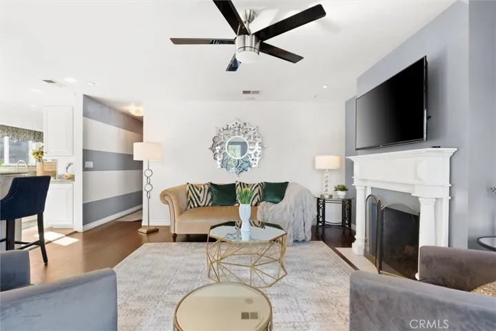 View of the living room and kitchen access. Built in fireplace and a lot of natural light.