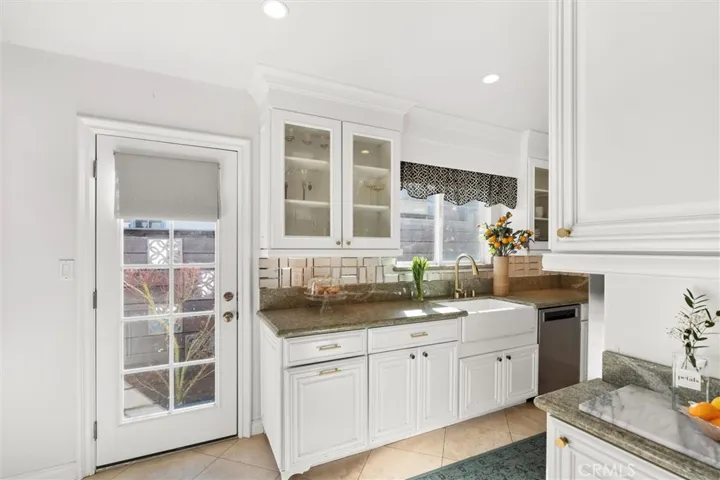 Access to side yard from the kitchen. Windows allow for natural light. Bright white cupboards and granite counters.